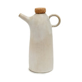White ceramic oil dispenser with cork lid on a white background