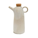 White ceramic oil dispenser with cork lid on a white background
