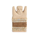Sandstone statue with cowrie shells and jute wrap
