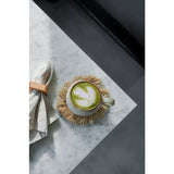 Cup of green tea with latte art on a marble surface