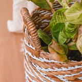 White and beige woven water hyacinth basket with striped pattern