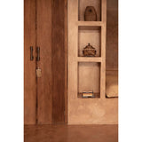 Wooden wardrobe with open door revealing shelves inside a room.