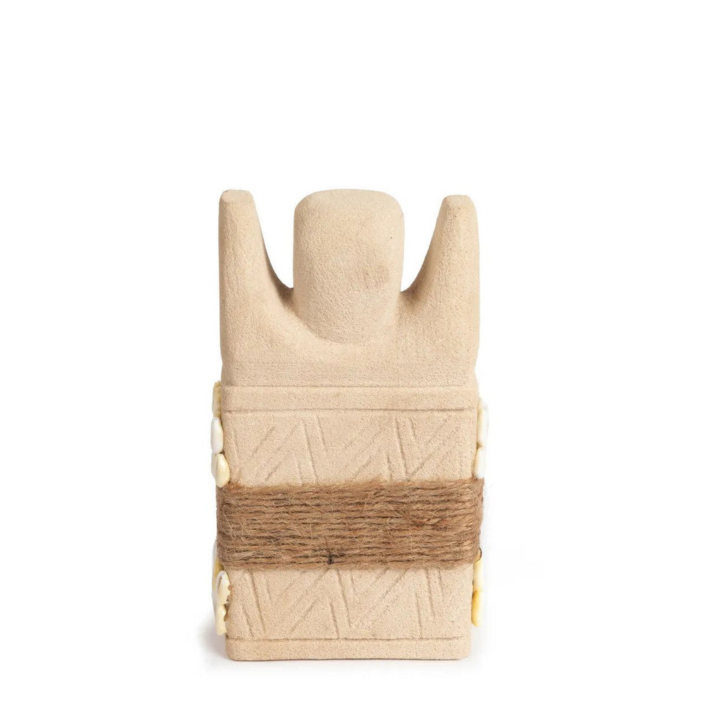 Sandstone statue with cowrie shells and jute wrap