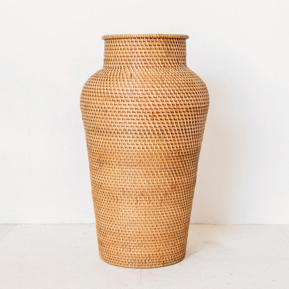 Woven rattan vase on a white background