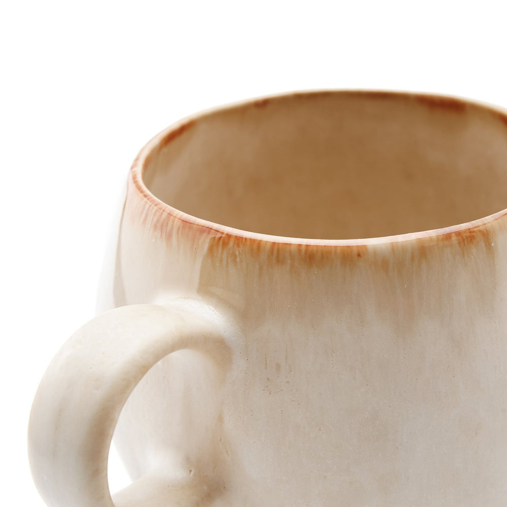 Close-up of a ceramic mug with a handle on a white background
