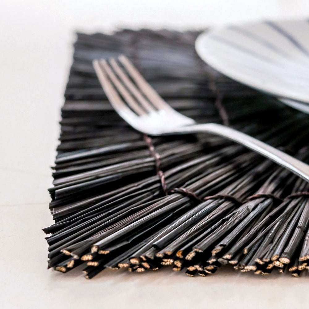 Black seagrass placemat with radial woven pattern