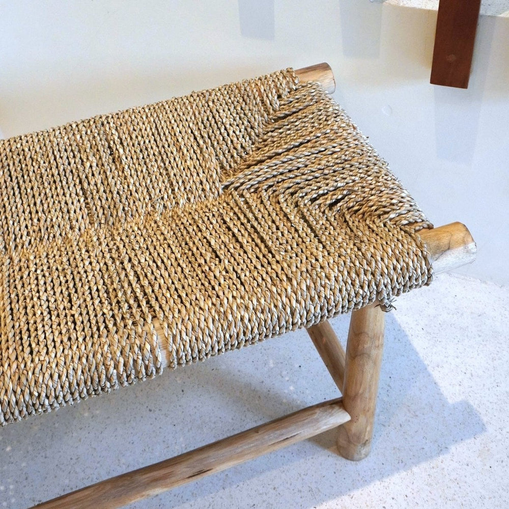 Beige wood bench with woven seagrass seat