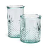 Two textured glass tumblers on a white background