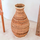 Beige and brown handwoven banana fiber vase with raffia accents