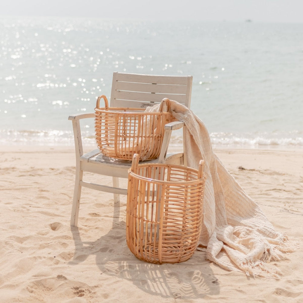 Beige woven rattan laundry basket with handles