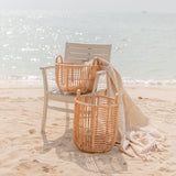 Beige woven rattan laundry basket with handles