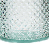 Close-up of a textured glass container with 'Baccarat' branding.