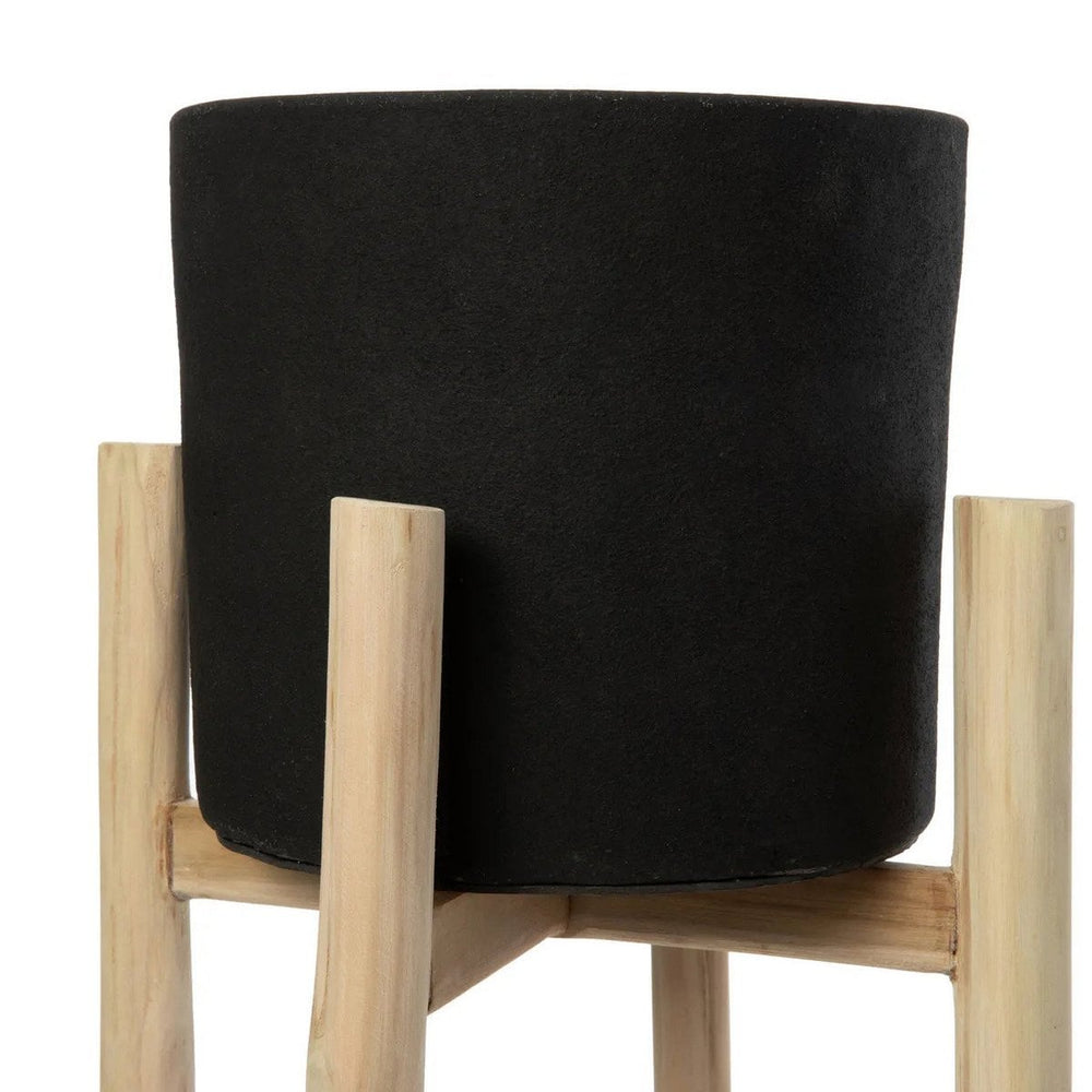 Black terracotta planter on teak branch stand