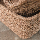 Close-up of two woven baskets on a stone surface