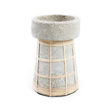 Concrete planter with woven rattan around it on a white background