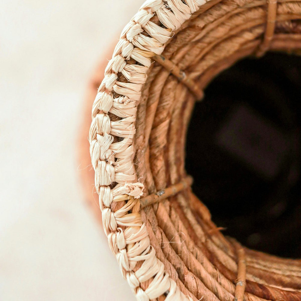 Beige and brown handwoven banana fiber vase with raffia accents