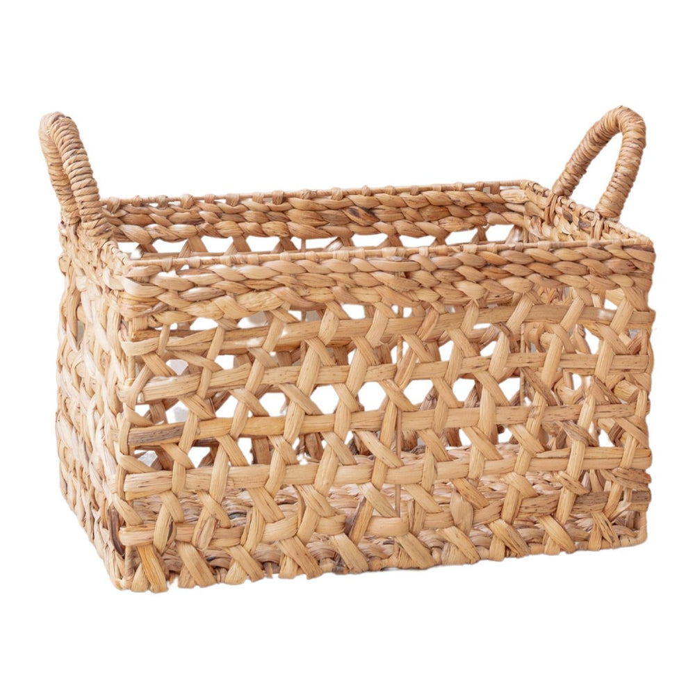 Woven rattan basket with handles on a white background