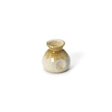 Beige ceramic sauce pourer with white honey glaze