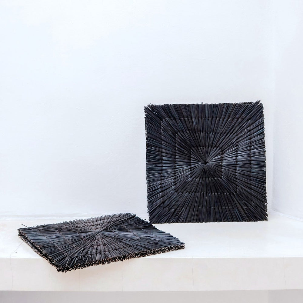Black seagrass placemat with radial woven pattern
