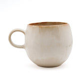 Beige ceramic mug on a white background
