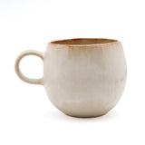 Beige ceramic mug on a white background