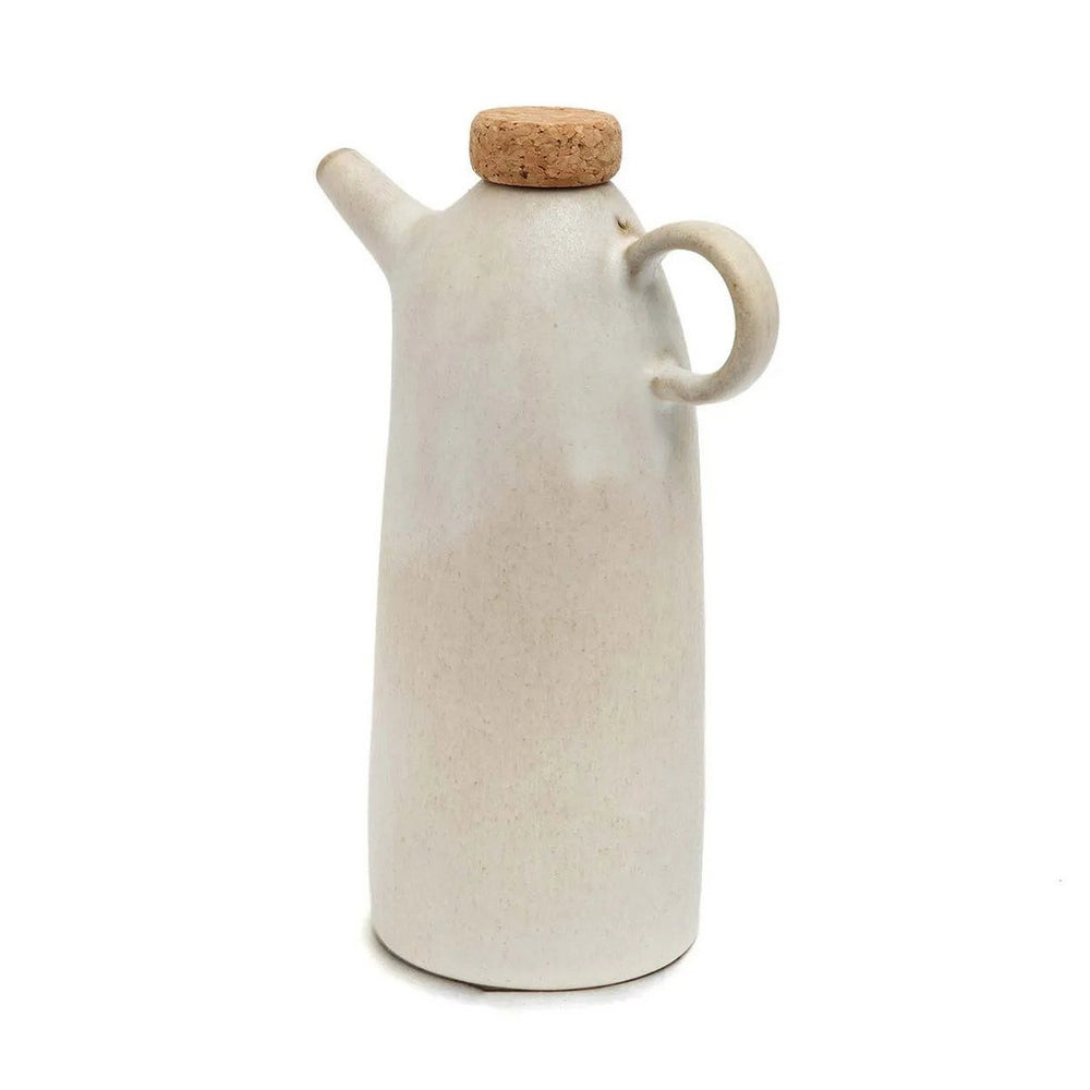 White ceramic oil dispenser with cork lid on a white background