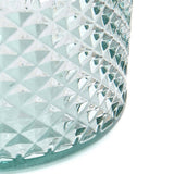 Close-up of a crystal glass with diamond cut pattern on a white background