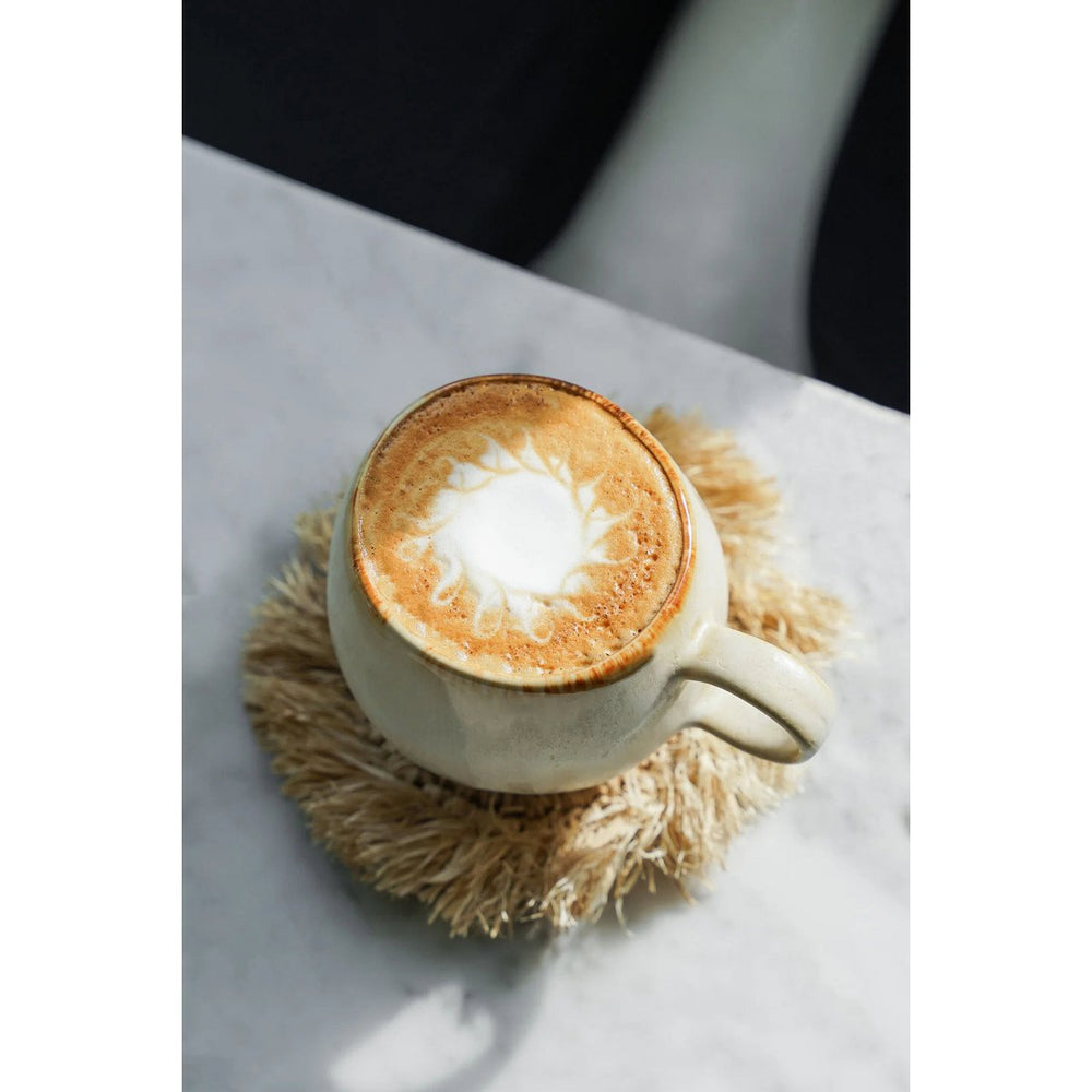 Natural raffia coaster with fringed edge