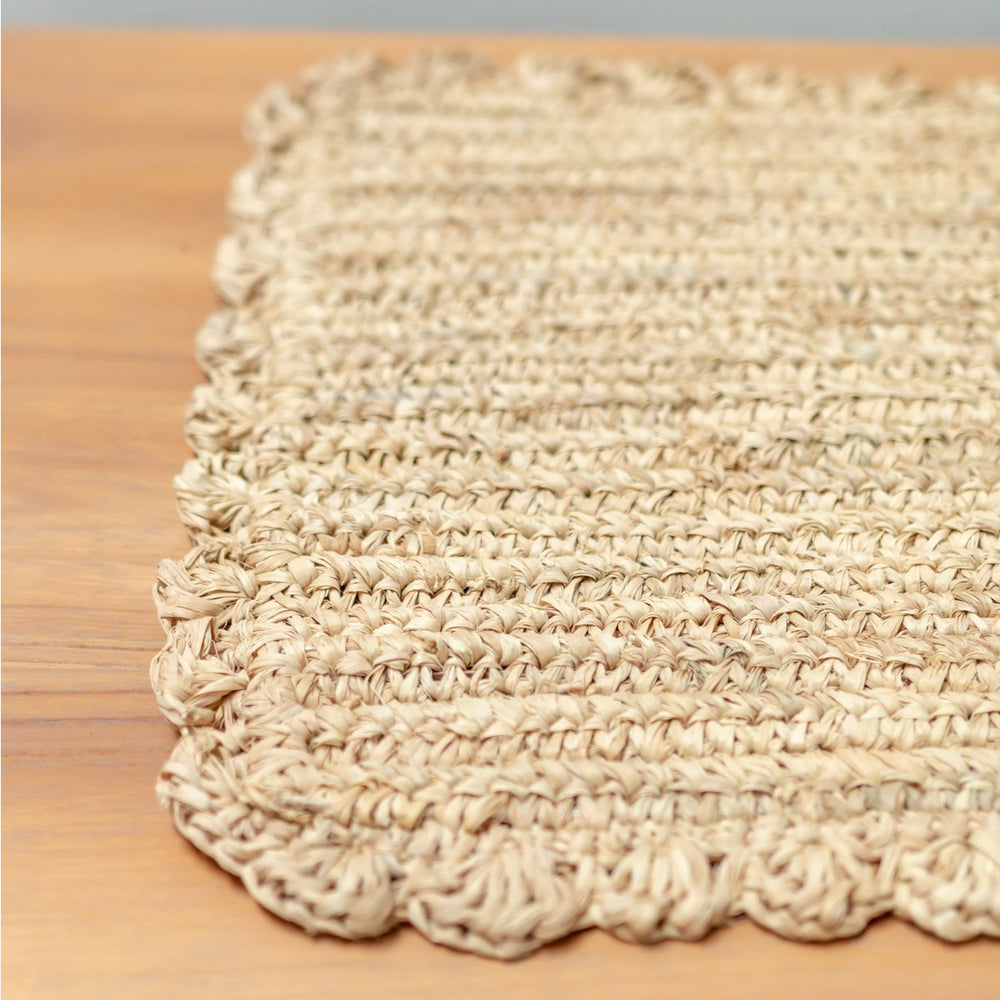 Beige woven placemat on a wooden surface