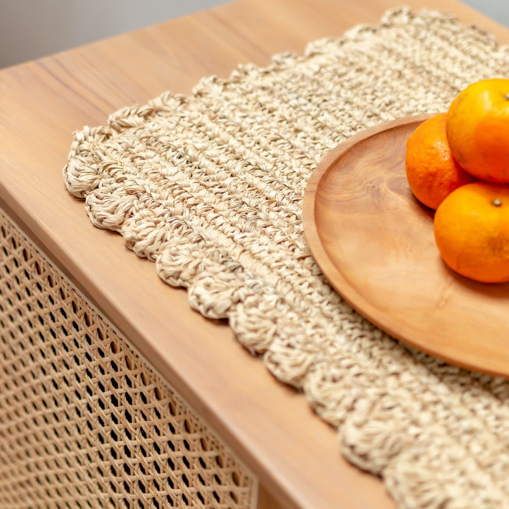 Wooden plate with oranges on a textured surface