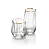 Two clear glass tumblers with gold rims on a white background