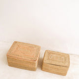 Two woven boxes on a light beige background