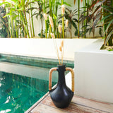 Black clay bottle vase with rattan-wrapped handles