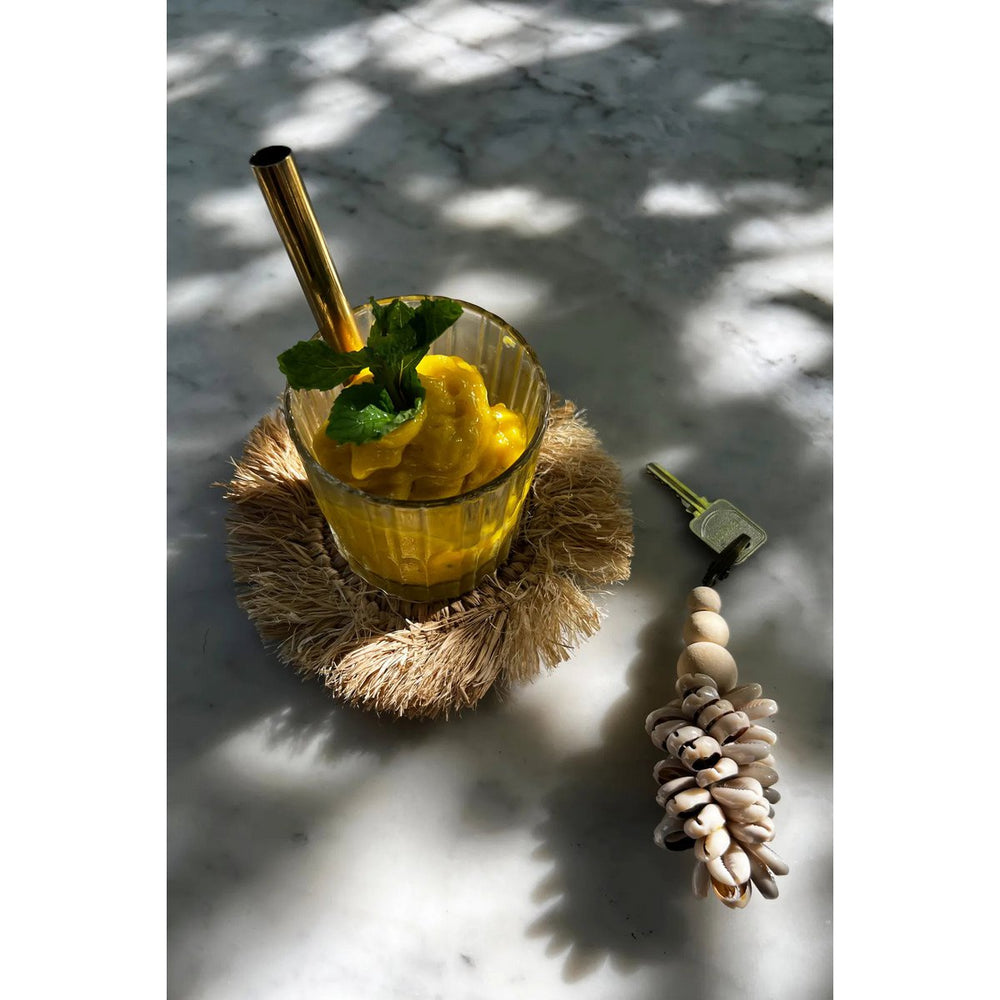 Natural raffia coaster with fringed edge