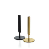 Black and gold candle holders on a white background
