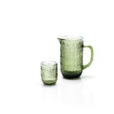 Green glass pitcher and tumbler on a white background