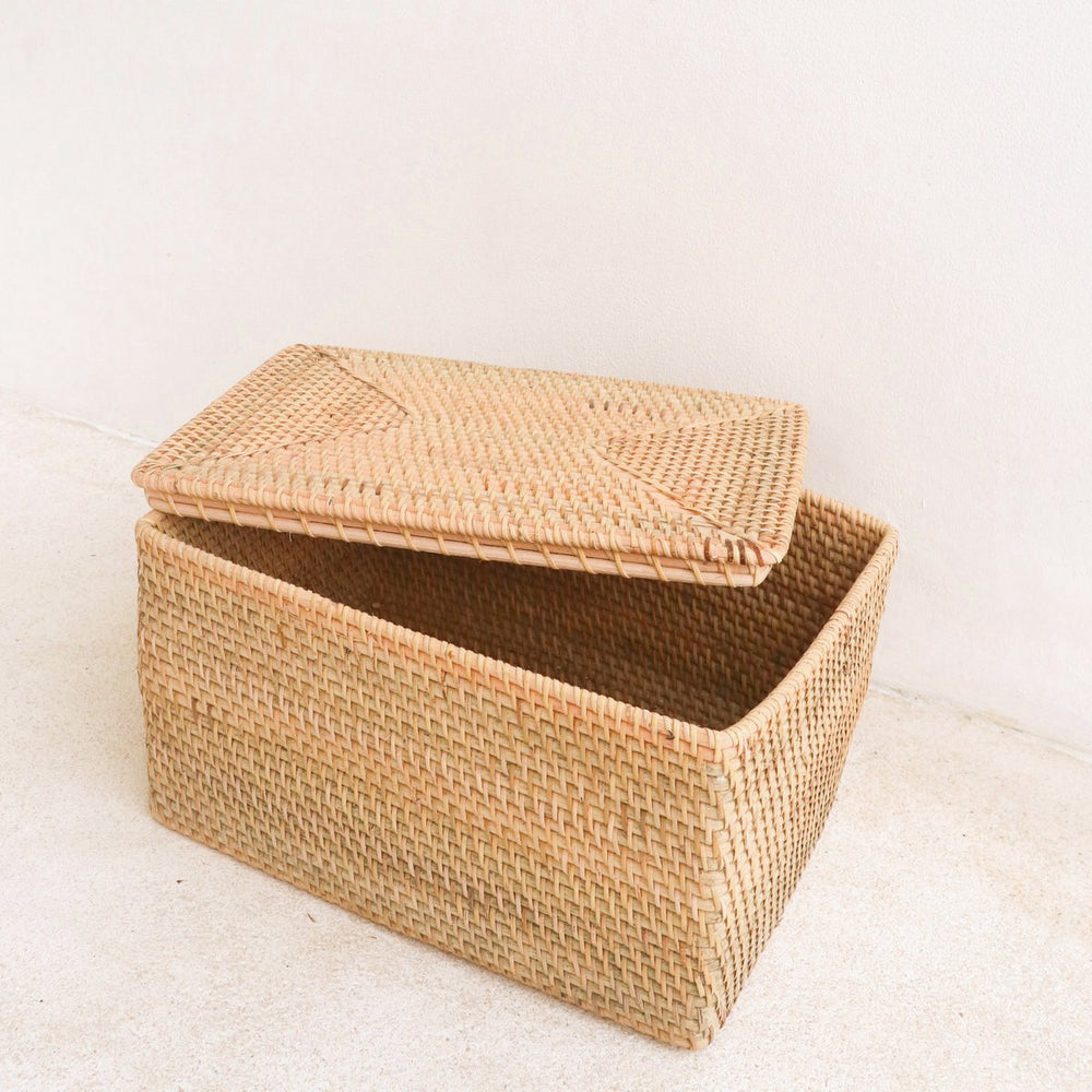 Woven storage box with lid on a light background