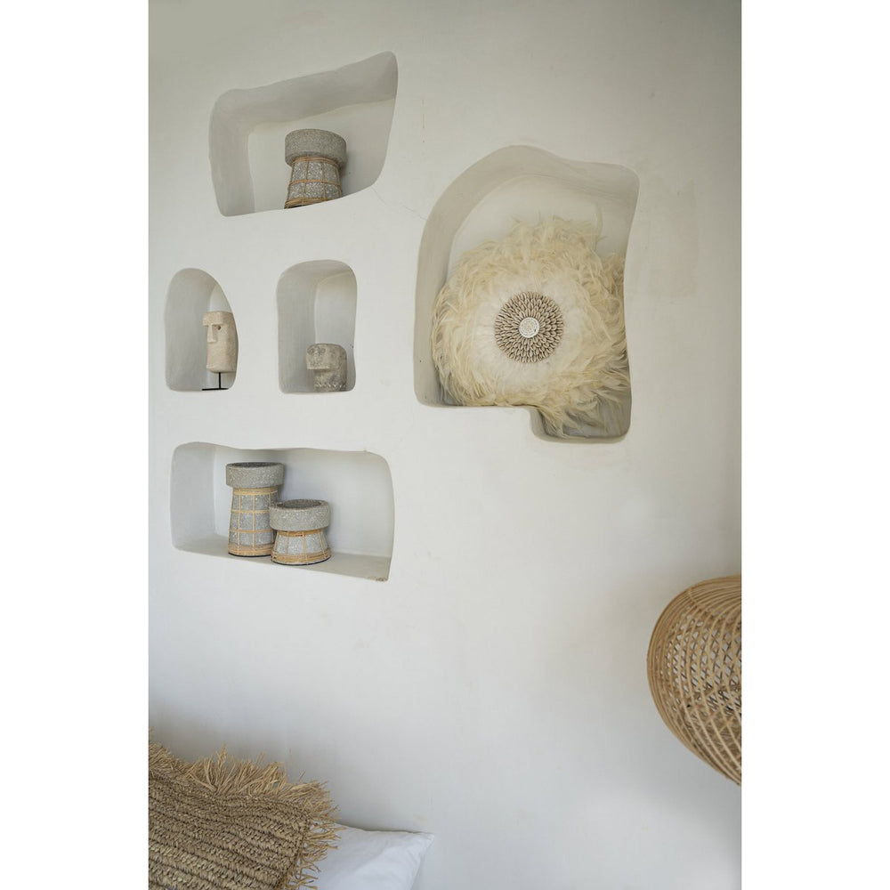 Decorative wall shelves with natural materials on a white wall