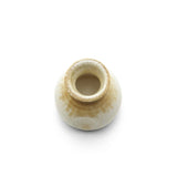 Beige ceramic sauce pourer with white honey glaze