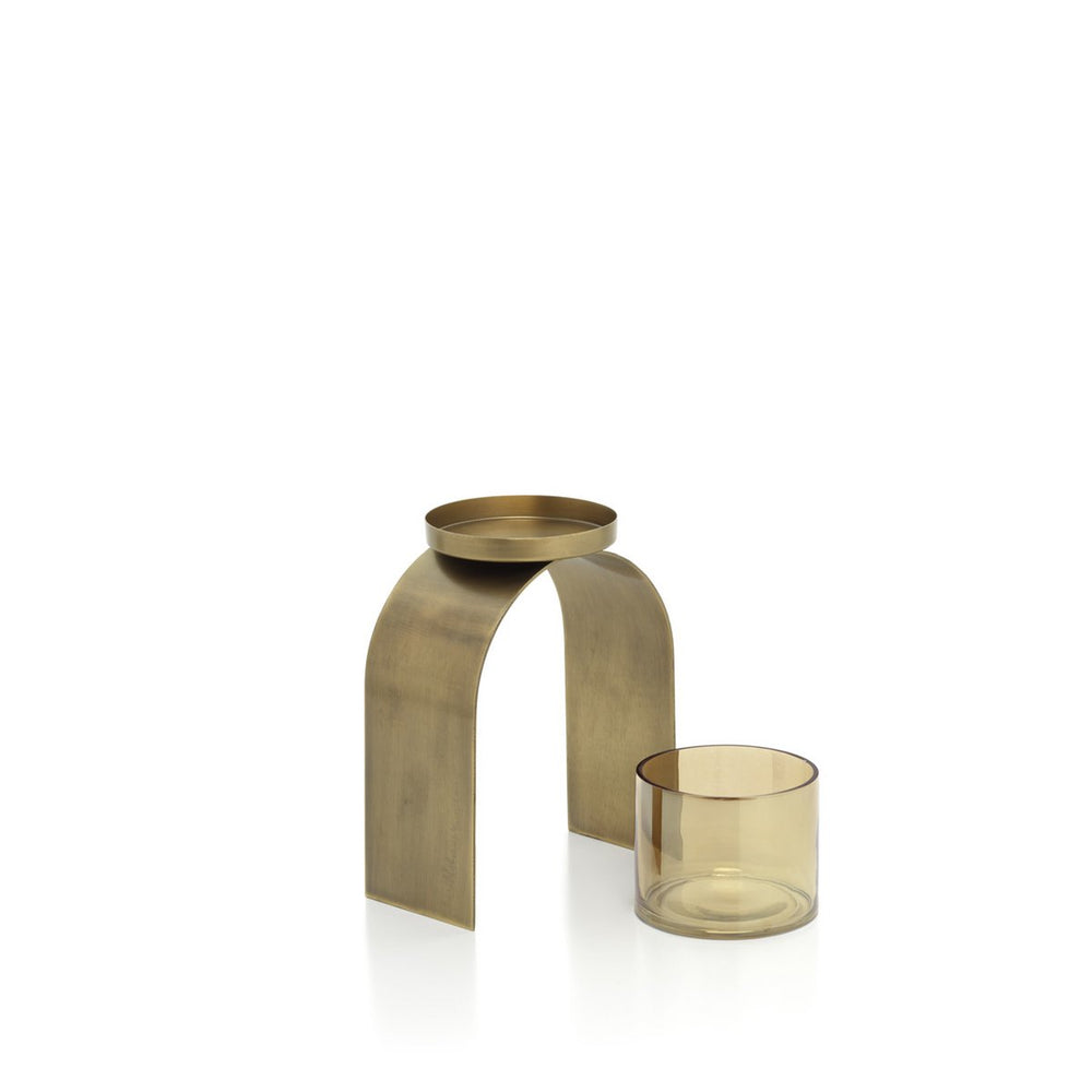 Brass candle holder with a glass candle on a white background