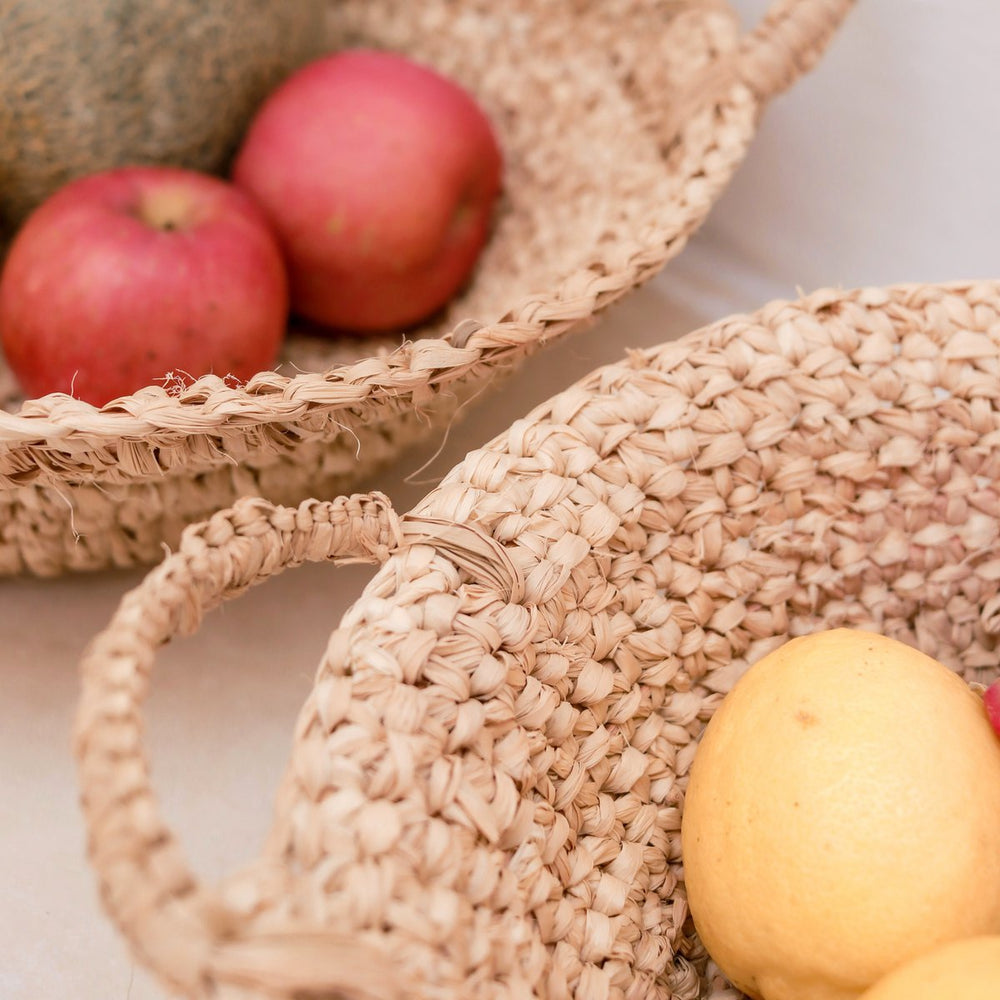 Woven baskets with fruits on a light background