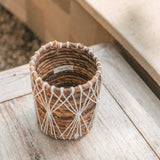 Brown and white woven banana fibre storage basket with cotton macramé lacing