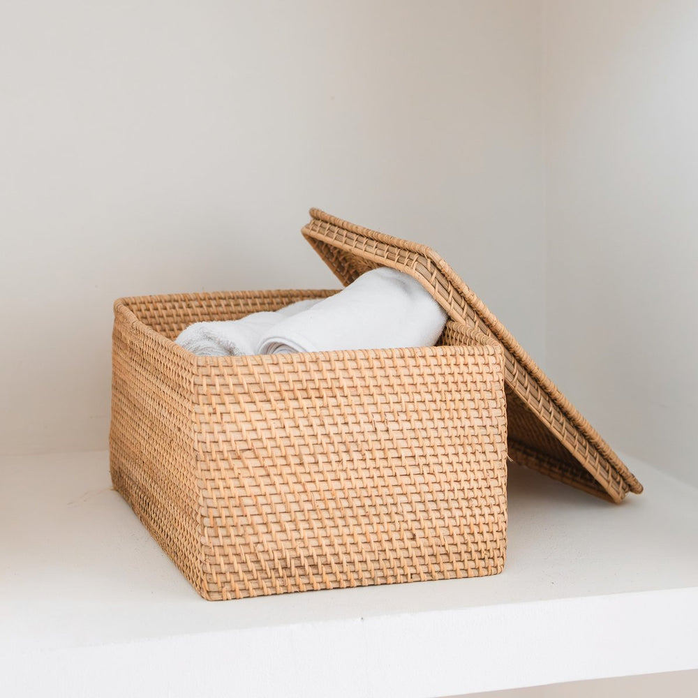 Woven storage basket with a lid on a light surface