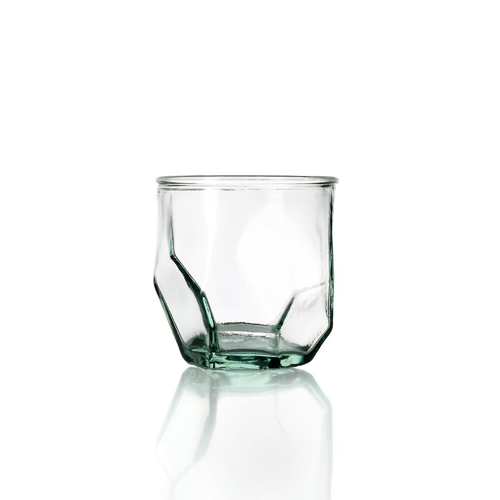 Clear geometric glass tumbler on a white background