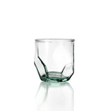 Clear geometric glass tumbler on a white background