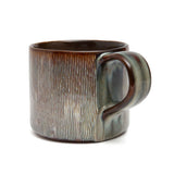 Ceramic mug with a textured surface on a white background