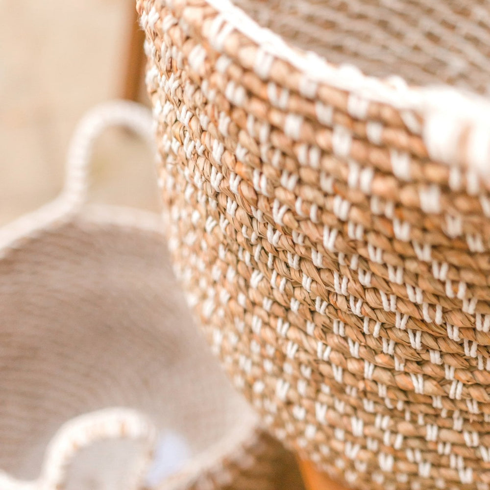 Beige woven banana fibre storage basket with white cotton cord pattern