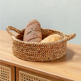 Woven basket with bread on a wooden surface