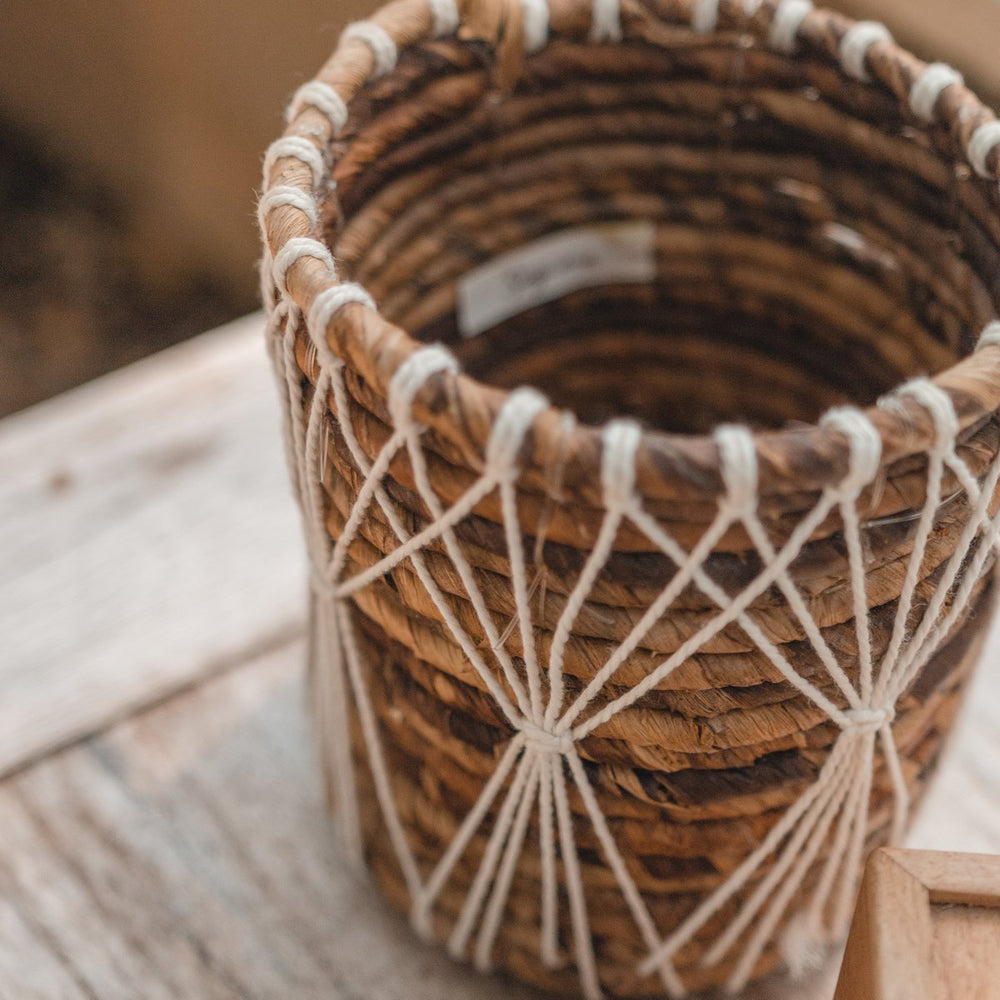Brown and white woven banana fibre storage basket with cotton macramé lacing