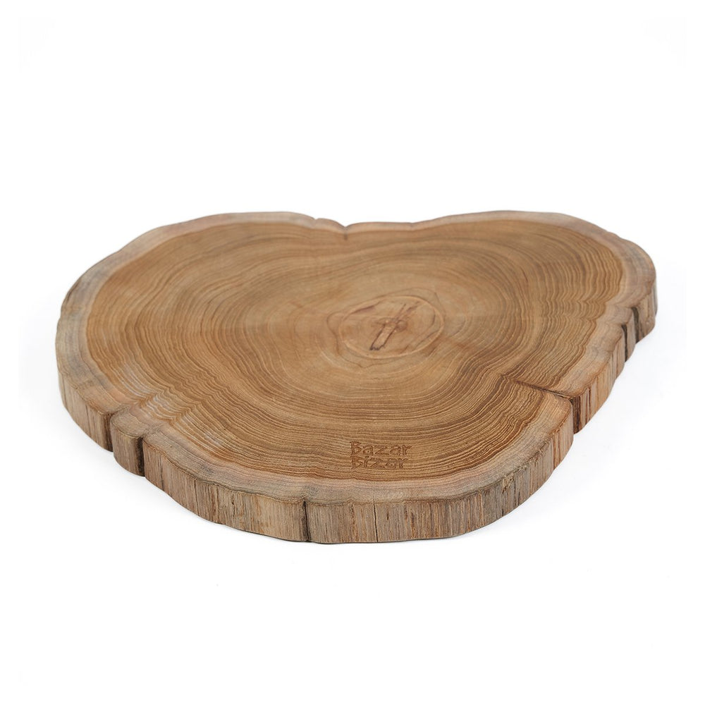 Brown teak wood cutting board with natural root shape
